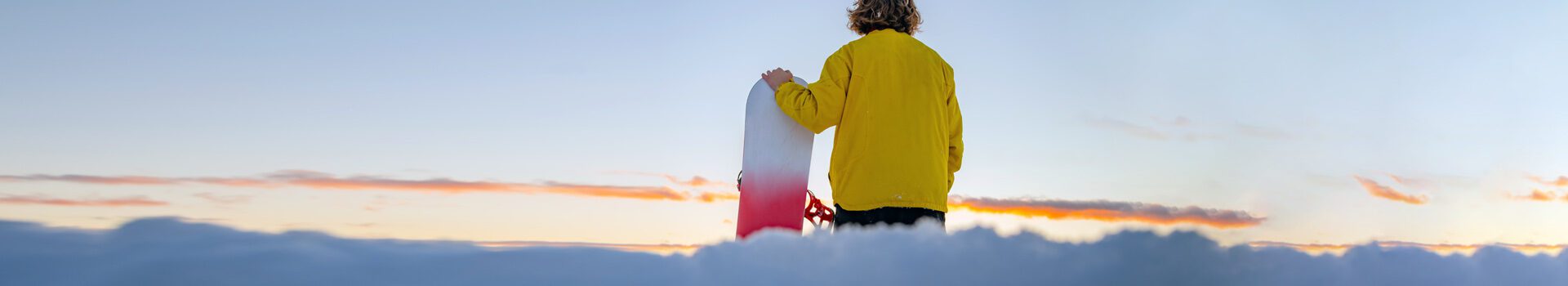 (Header photo) Snowboarder gazing on the sunset