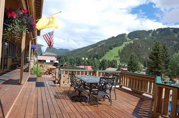 An outdoor patio overlooking the Red River Ski area in summer