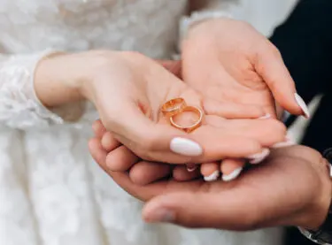 A couple's hands with wedding rings