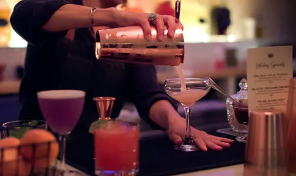 A cocktail being served at a bar