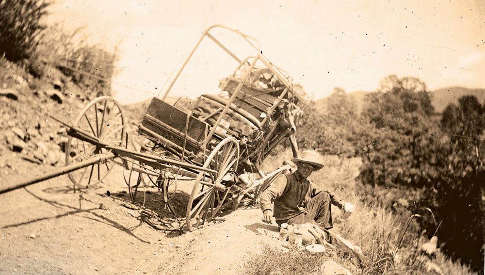 Ernest Blumenschein with a broken wagon wheel