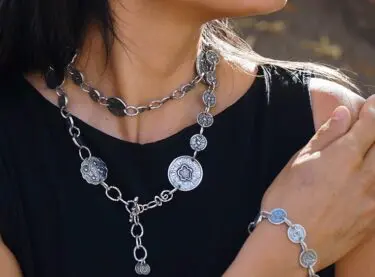 A person modeling Claireworks jewelry