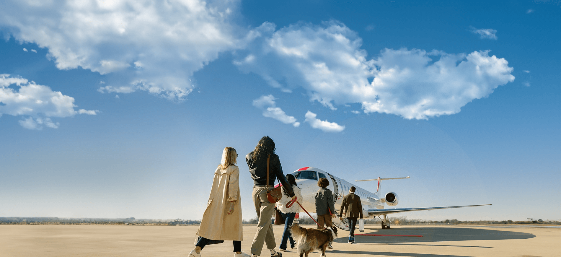 People walking on the tarmac to board a JSX plane.