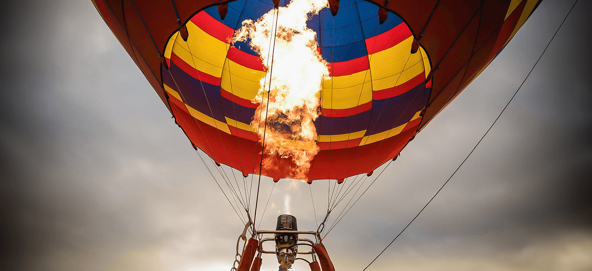 A close-up photo of a hot air balloon with flames.