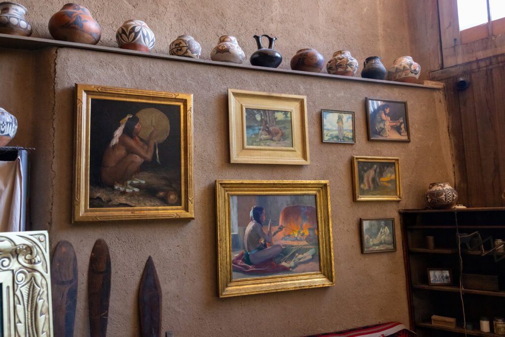 E.I. Couse paintings hang on the wall of his historic studio.