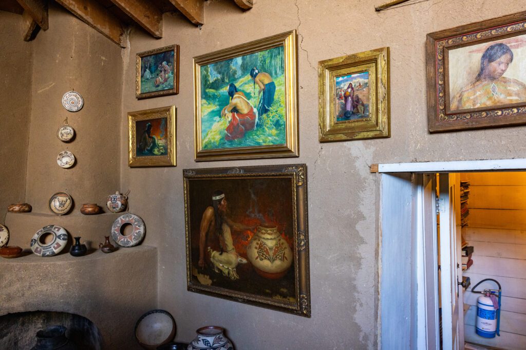 E.I. Couse paintings of native Americans on a brown wall 