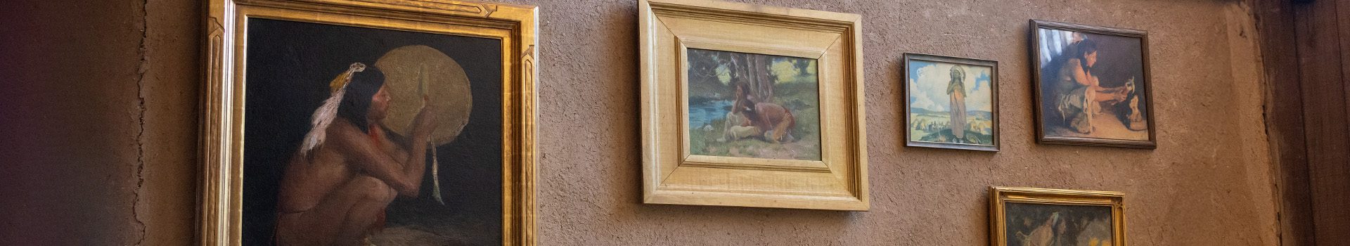 Native American paintings on a brown wall